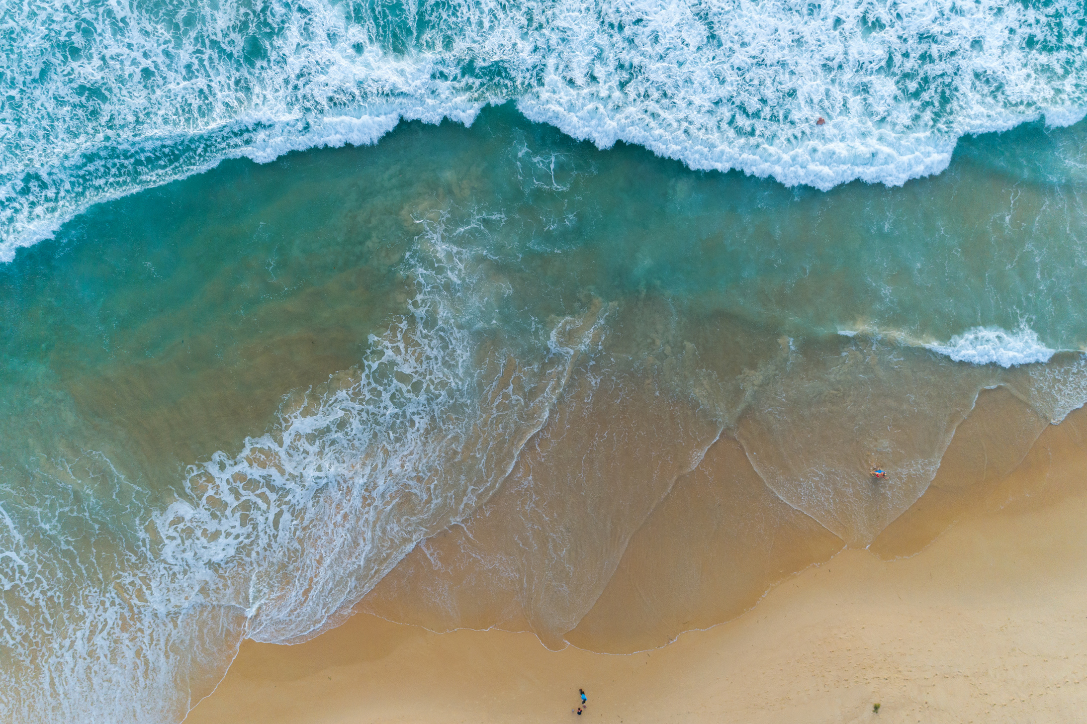 Aerial View of  Sandy Beach and Crashing Waves